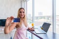 Sexy girl sitting smiling and hand holding credit card with happiness