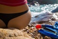 girl in sportswear and tanga string sitting on the cliff of Royalty Free Stock Photo