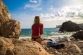 girl in sportwear and tanga on the rocky beach Royalty Free Stock Photo