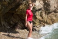 girl in sportwear and tanga on the rocky beach Royalty Free Stock Photo