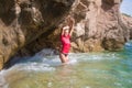 girl in sportwear and tanga on the rocky beach Royalty Free Stock Photo