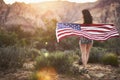 Sexy girl standing with american flag in nevada desert at sunset Royalty Free Stock Photo