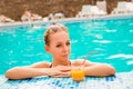 Sexy girl swimming in a pool with juice and glasses Royalty Free Stock Photo