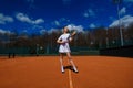 Sexy girl tennis player holding tennis racket on the court. Young woman is playing tennis Royalty Free Stock Photo