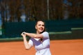 Sexy girl tennis player holding tennis racket on the court. Young woman is playing tennis Royalty Free Stock Photo