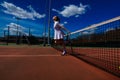 Sexy girl tennis player holding tennis racket on the court. Young woman is playing tennis Royalty Free Stock Photo