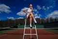 Sexy girl tennis player holding tennis racket on the court. Young woman is playing tennis Royalty Free Stock Photo