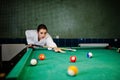 Sexy girl in white bathrobe play pool billiards Royalty Free Stock Photo