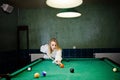 Sexy girl in white bathrobe play pool billiards Royalty Free Stock Photo