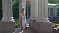 sexy greek goddess is dancing erotically near columns of palace