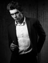 handsome male model posing in black fashion suit and white Royalty Free Stock Photo