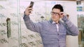 sexy Handsome young man in glasses, spectacles makes selfie at optical store, optics, optician retail store, Eyeglasses Royalty Free Stock Photo