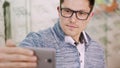 sexy Handsome young man in glasses, spectacles makes selfie at optical store, optics, optician retail store, Eyeglasses Royalty Free Stock Photo