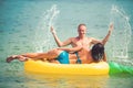 Sexy happy couple on Caribbean sea. Pineapple inflatable mattress, activity joy. Maldives or Miami beach water. Couple Royalty Free Stock Photo