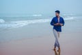 Sexy Indian men model walking on beach sea view background with space for copy text. Handsome and confident men. Outdoor portrait Royalty Free Stock Photo