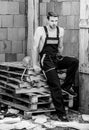 Sexy laborer. Building construction. Worker brick wall background. Man build own house. Perform basic tasks. Masculinity Royalty Free Stock Photo