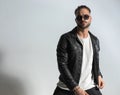 Sexy latin man wearing black leather jacket and sunglasses and posing Royalty Free Stock Photo