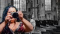 Sexy latin mexican woman with long black hair taking a picture inside a church through a mirror