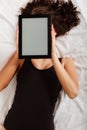 lazy girl lying with tablet touchpad on bed