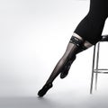 legs of a young woman in black stockings Royalty Free Stock Photo