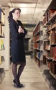 A librarian standing in the stacks