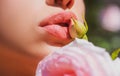 Sexy Lips. Beauty Red Lips Makeup Detail. Lips with spring flowers closeup. Beautiful woman lips with rose. Royalty Free Stock Photo