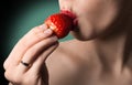 lips with strawberry. Natural skin. Green background. Hot k