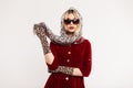 Sexy luxurious young woman in fashionable sunglasses with beautiful lips in vintage scarf in red elegant dress in trendy leopard Royalty Free Stock Photo