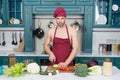 Sexy macho wear cook uniform. man in kitchen. good husband and housekeeper. cooking healthy food. time for dinner Royalty Free Stock Photo