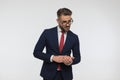 Sexy man with glasses wearing elegant suit and rubbing palms Royalty Free Stock Photo