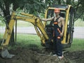 Sexy man with nude torso near construction equipment or excavator Royalty Free Stock Photo