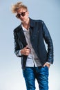 man posing while holding his leather jacket with sunglasses Royalty Free Stock Photo