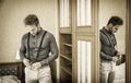 man standing and dressing in bedroom Royalty Free Stock Photo