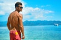 Man Tanning With Sunblock Skin Cream On Summer Beach.