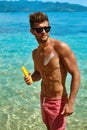 Man Tanning Using Sunscreen Cream On Body Skin. Summer Royalty Free Stock Photo