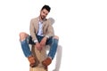 man wearing brown suit sitting on wooden boxes Royalty Free Stock Photo