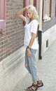 model poses in white t-shirt and jeans - city Royalty Free Stock Photo