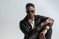 Sexy modern man in black leather jacket with sunglasses posing Royalty Free Stock Photo