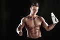 sexy muscular male torso and body of handsome macho man or athlete guy workout or training, holds white thermo mug Royalty Free Stock Photo