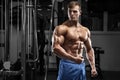 muscular man in gym. Strong male torso abs, workout Royalty Free Stock Photo