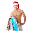 muscular shirtless man in Santa Claus hat