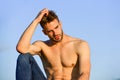 Sexy pensive man relaxing outdoors. Male beauty. Fashion guy. Attractive and mysterious. Athletic handsome macho