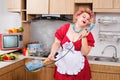 Sexy pinup plus size caucasian woman in cook`s chatting by phone on the kitchen Royalty Free Stock Photo