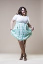 plus size fashion model in casual clothes, fat woman on beige studio background, overweight female body Royalty Free Stock Photo