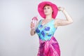 Sexy plus size girl in a blue swimsuit, fuchsia hat with brim and in a trendy bright pareo stands on a white background in the Stu Royalty Free Stock Photo