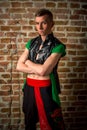 portrait of a very muscular Caucasian male model dancer in national costume against a brick wall Royalty Free Stock Photo