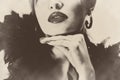 pretty beautiful woman with black feathers, shiny lips sepia retro vintage