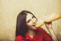 Sexy pretty brunette smiling woman eats big sandwich or burger Royalty Free Stock Photo