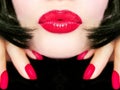 pretty woman with black hair, red lips and fingernails sending a kiss / smooch Royalty Free Stock Photo