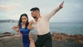 Sexy performers dancing tango on gloomy sea coast. Dancers performing hot latino Royalty Free Stock Photo